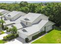 An aerial perspective of well-maintained homes surrounded by lush trees, offering a serene living environment at 1624 Lullwater Ln, Lutz, FL 33549