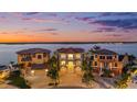 Waterfront homes with lush landscaping, private docks and beautiful sunset views, ideal for luxury living at 16365 Redington Dr, Redington Beach, FL 33708