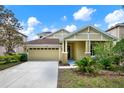 Charming single-Gathering home featuring an attached two-car garage and well-maintained landscaping at 20106 Bending Creek Pl, Tampa, FL 33647