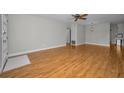Open concept living room with light gray walls, wood flooring, and modern ceiling fan at 2073 Denmark St # 9, Clearwater, FL 33763
