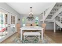 Inviting dining room with natural light, featuring a white table set, wooden chairs, and a stylish area rug at 2311 64Th Street W Ct, Bradenton, FL 34209
