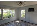 Living room with light blue walls, wood-look flooring, and multiple windows at 2326 Melrose S Ave, St Petersburg, FL 33712