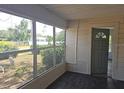 Enclosed porch features multiple windows, a door to the home, and plank flooring at 2326 Melrose S Ave, St Petersburg, FL 33712