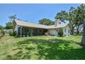 Expansive back yard features a screened in lanai with ample seating room and lush landscaping at 2517 Bucknell Dr, Valrico, FL 33596
