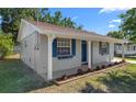 Beautiful house featuring lush lawn, attached garage, landscaping, and a freshly painted facade at 2613 E 113Th Ave, Tampa, FL 33612