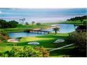 Scenic golf course view showcasing lush greens, water features, and a beautiful waterfront backdrop at 2620 Cove Cay Dr # 704, Clearwater, FL 33760
