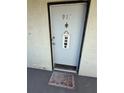 Unit 913's front door with decorative welcome sign and mat enhances the entryway's charm at 2625 State Road 590 # 913, Clearwater, FL 33759
