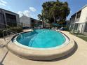 Community pool with lounge chairs and umbrellas offer residents a relaxing outdoor space at 2625 State Road 590 # 913, Clearwater, FL 33759