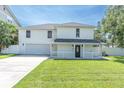 Inviting two-story home with a covered front porch and well-manicured lawn at 2807 57Th S St, Gulfport, FL 33707