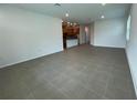 Spacious living room featuring tile flooring and an open layout to the kitchen at 28547 Hillcrest Valley Blvd, Wesley Chapel, FL 33543