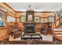 Warm and inviting living room featuring a cozy fireplace and rustic wood accents at 3112 W Wallcraft Ave, Tampa, FL 33611