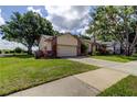 Landscaped home on a corner lot with a beautiful yard, and driveway at 3410 Briarwood Ln, Safety Harbor, FL 34695