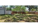 Spacious backyard featuring a shed, mature trees, and a wooden fence for privacy at 3680 19Th S Ave, St Petersburg, FL 33711