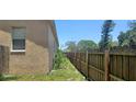 Exterior shot showcasing the side of the property with a privacy fence and lawn at 3680 19Th S Ave, St Petersburg, FL 33711