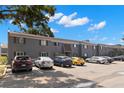 Well-maintained gray two-story condo building showcasing ample parking space under a bright, sunny sky at 4032 Cortez Dr # A, Tampa, FL 33614