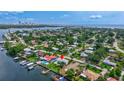 Stunning aerial view of waterfront home with dock, pool, and city skyline in the distance at 4099 Pompano Se Dr, St Petersburg, FL 33705