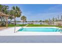 Relaxing pool area with views of mature landscaping and the tranquil bay, perfect for outdoor enjoyment at 4099 Pompano Se Dr, St Petersburg, FL 33705