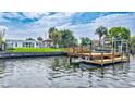 Picturesque view of the waterfront property featuring a private dock, perfect for boating and enjoying the serene surroundings at 4099 Pompano Se Dr, St Petersburg, FL 33705