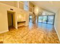 Bright living room featuring tile floors, wet bar, high ceilings, and sliding doors to patio at 4117 Muriel Pl, Tampa, FL 33614