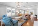 Bright living room featuring hardwood floors, decorative ceiling, and large windows at 419 W Osborne Ave, Tampa, FL 33603