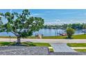 Scenic waterfront view featuring lush trees, a private dock, and tranquil water at 4321 Sunrise S Dr, St Petersburg, FL 33705