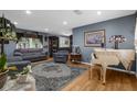Spacious living room with hardwood floors, comfortable seating, and a decorative white piano at 4499 Collins Rd, Spring Hill, FL 34606
