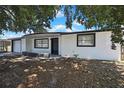 Charming single-story home featuring a white exterior, well-maintained garage, and inviting front porch at 5053 Lofton Dr, New Port Richey, FL 34652