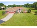 Charming single-story home boasting an attached garage and lush lawn at 5100 Lockhart Rd, Brooksville, FL 34602