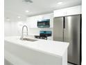 Bright kitchen with white cabinetry, stainless steel appliances, and a large center island at 5510 12Th St, Zephyrhills, FL 33542