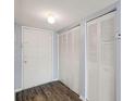 Hallway featuring updated vinyl floors, closet doors, and a neutral color palette at 6324 Newtown Cir # 24B1, Tampa, FL 33615