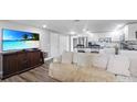 Open floor plan showcasing the living room with kitchen featuring modern appliances and island seating at 6334 Hyperion Dr, Port Richey, FL 34668