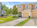 Well-maintained townhome with lush front lawn and convenient two-car garage in a desirable community at 6974 Holly Heath Dr, Riverview, FL 33578