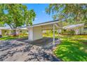 Carport with storage shed on a sunny day. Features parking and secure storage space at 70 Cypress Pl, Oldsmar, FL 34677