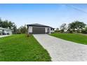 Attractive one-story home has a spacious paved driveway leading to the attached two-car garage at 7054 Rosemont Dr, Englewood, FL 34224