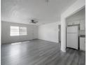 Open living area featuring new flooring, fresh white paint, and a ceiling fan at 725 2Nd Ne Ave, Largo, FL 33770