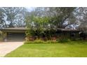 Well-maintained lawn and tropical landscaping accentuate the exterior of this attractive, single story home at 8260 32Nd N Ave, St Petersburg, FL 33710