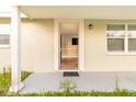 Inviting covered front porch leads to the front door with an open view of the home's interior at 9020 Gray Fox Ln, Port Richey, FL 34668