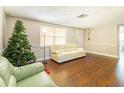 Comfortable living area featuring hardwood floors, large windows, and ample space for entertaining at 9020 Gray Fox Ln, Port Richey, FL 34668