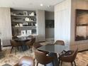 Inviting common area featuring modern tables, chairs, and stylish decor on built-in shelving at 100 1St N Ave # 702, St Petersburg, FL 33701