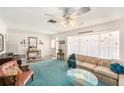 Cozy living room with bright windows, a plush sofa, and traditional decor for comfortable living at 10400 112Th Way, Largo, FL 33778
