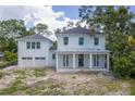 Charming two-story home featuring a covered front porch with stately columns and a two-car garage at 116 24Th S Ave, St Petersburg, FL 33705