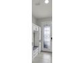 Bright foyer featuring built-in cabinets and drawers with a stylish glass-paneled door at 1203 Custer Bayou Street, Ruskin, FL 33570