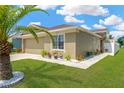 Beautiful single-story home featuring well-manicured lawn and tidy landscaping around the foundation at 12925 Fieldmoor Ct, Riverview, FL 33579