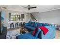 Living room featuring a large sectional sofa and open access to the kitchen at 16076 Dawnview Dr, Tampa, FL 33624
