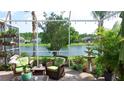 Screened lanai with comfortable seating and a view of the lake and fountain at 16515 Nikki Ln, Odessa, FL 33556