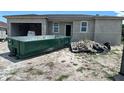 Image of a home under construction with a dumpster in front of the property at 17349 Pheasant Cir, Port Charlotte, FL 33948
