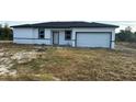 Exterior of a newly constructed single-story home featuring an attached garage at 19233 Wilton Ave, Port Charlotte, FL 33954