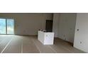 Bright unfinished living area with big sliding glass doors and an island at 19233 Wilton Ave, Port Charlotte, FL 33954