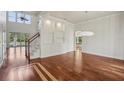 Bright and airy living room featuring high ceilings, hardwood floors, and an open staircase at 19803 Prince Benjamin Dr, Lutz, FL 33549