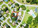 Aerial view of the home featuring a community pool, mature trees and nearby streets at 2212 Portside Psge, Palm Harbor, FL 34685